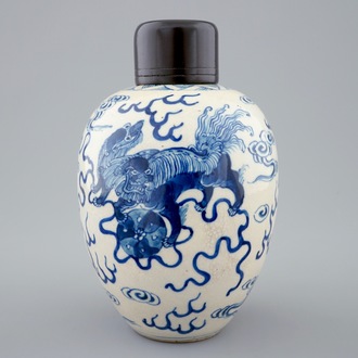 A Chinese blue and white soft paste jar with wooden cover, 19th C.